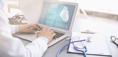 Cardiologist working with laptop at office. Health care concept.