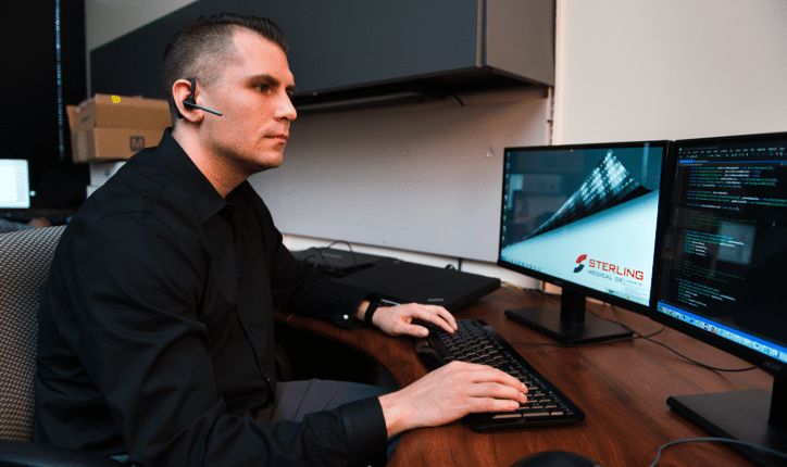 person sitting at a desk using a computer