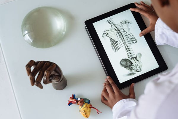 Doctor on tablet considering medical device artificial intelligence